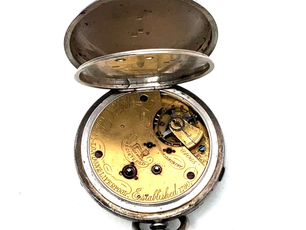 An antique silver open-face pocket watch featuring a white enamel dial with Roman numerals, centre seconds chronograph markings, and an attached top suspension loop. View X