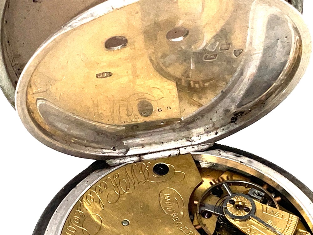 An antique silver open-face pocket watch featuring a white enamel dial with Roman numerals, centre seconds chronograph markings, and an attached top suspension loop. View XI