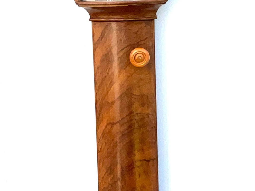 A wall-mounted antique Georgian stick barometer crafted from figured satinwood, featuring a brass finial, pediment top, and glass-fronted silvered scale. View III