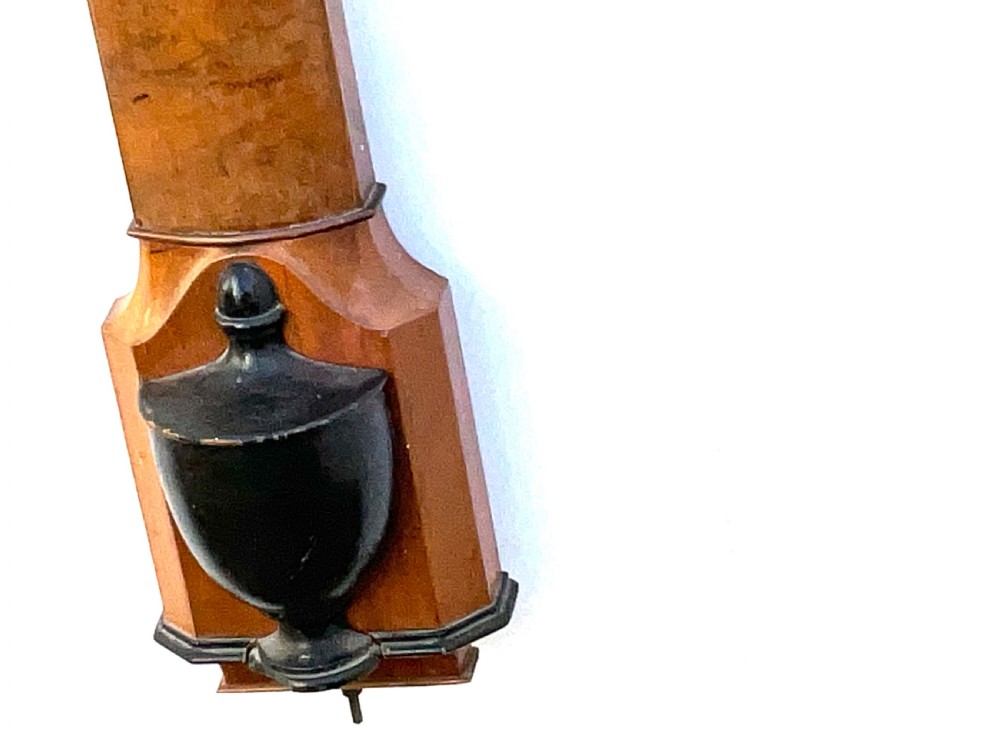 A wall-mounted antique Georgian stick barometer crafted from figured satinwood, featuring a brass finial, pediment top, and glass-fronted silvered scale. View VII