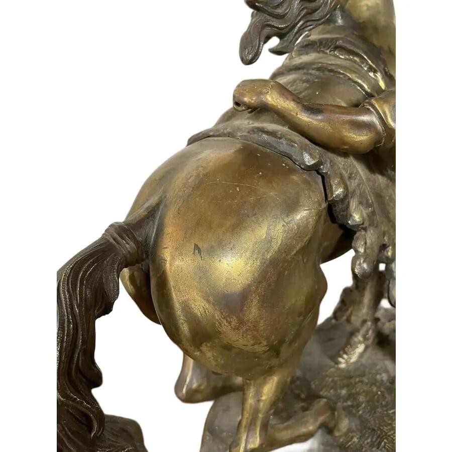 A pair of detailed gilt-bronze sculptures depicting rearing horses held by classical male handlers on naturalistic bases. View IV