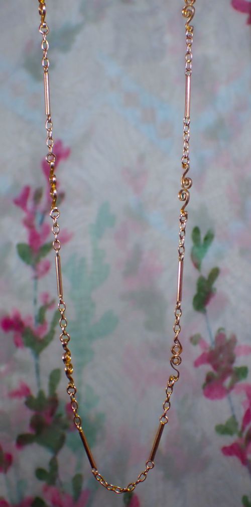 fig 1. An antique Victorian 9ct rose gold chain composed of alternating cylindrical bar links and coiled wirework scrolls.