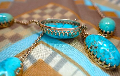fig 1. An Edwardian 9ct rose gold negligee necklace set with five oval matrix turquoise cabochons suspended on fine trace chains.