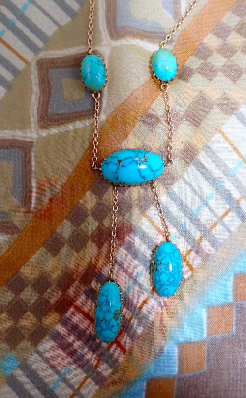 fig 2. An Edwardian 9ct rose gold negligee necklace set with five oval matrix turquoise cabochons suspended on fine trace chains.
