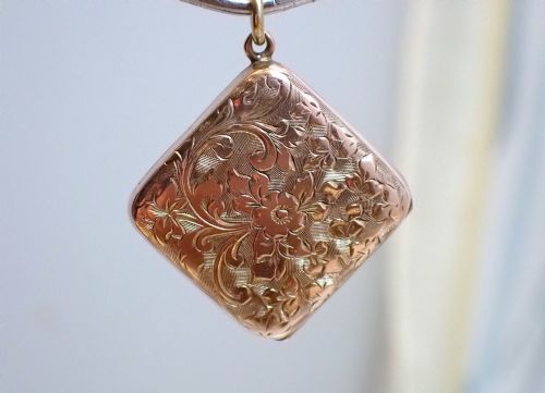 fig 3. An antique Victorian square rose gold double fronted locket with hand engraved floral patterns and a heart cartouche.