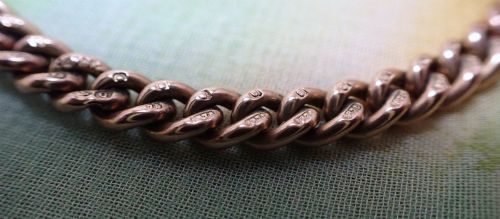 fig 2. An Edwardian 9ct rose gold curb link bracelet featuring interlocking links and a traditional swivel clasp closure.