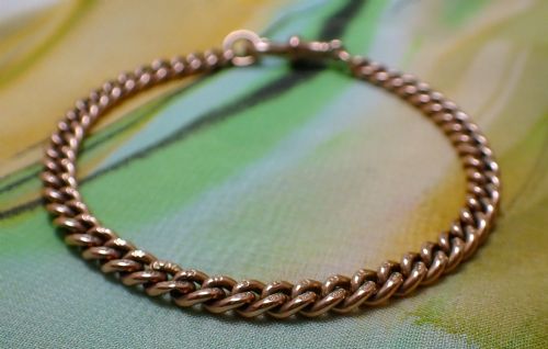 fig 3. An Edwardian 9ct rose gold curb link bracelet featuring interlocking links and a traditional swivel clasp closure.