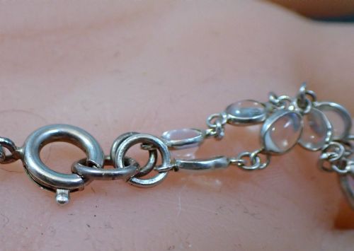 fig 4. An antique Arts and Crafts sterling silver double-strand necklace featuring bezel-set oval cabochon moonstones linked together by wire chain loops.