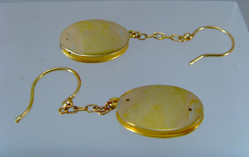 A pair of Victorian Etruscan Revival yellow gold oval drop earrings featuring central wirework detailing with seed pearls and diamonds suspended from chain links. View VII