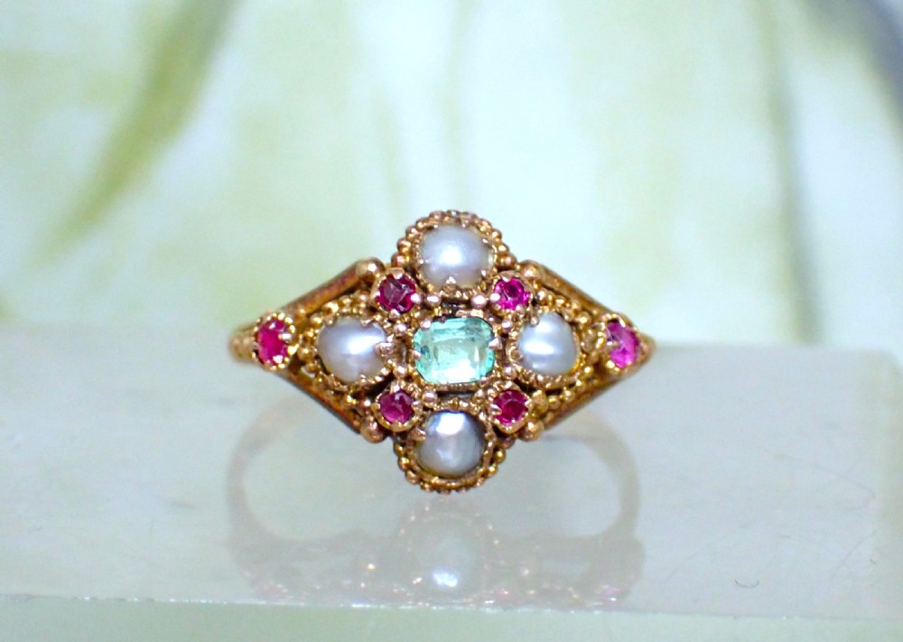 A Georgian 15ct gold ring featuring a central emerald framed by rubies and pearls in a cluster setting on a split-shank band. View III