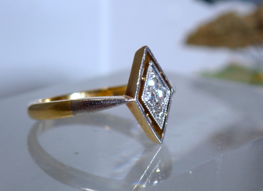 An Art Deco ring featuring a diamond-shaped lozenge motif set with four diamonds in platinum on an 18ct yellow gold band. View III
