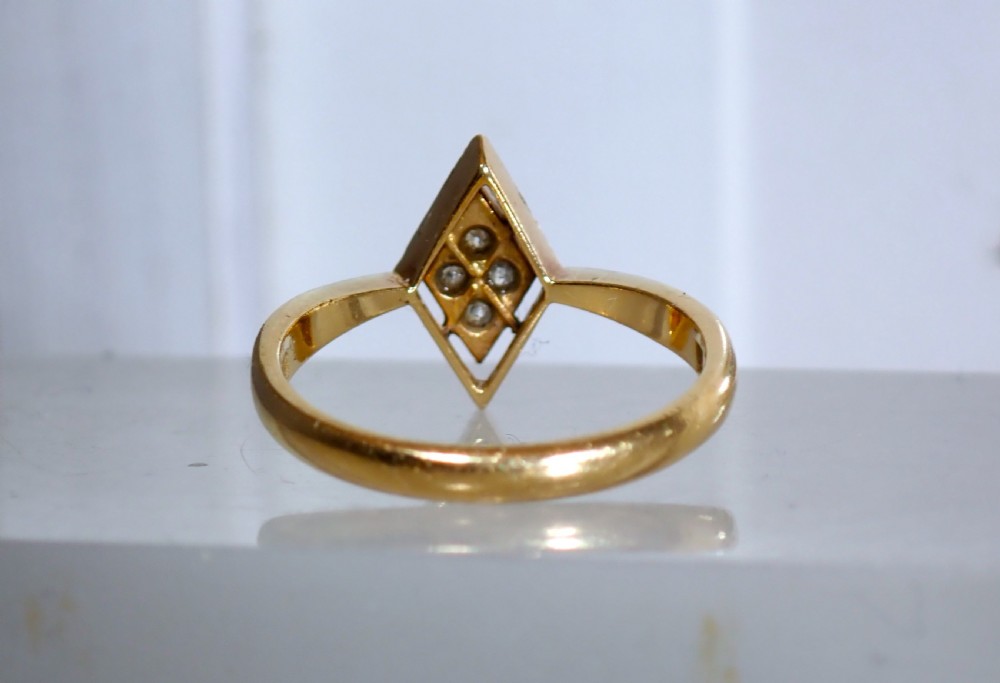 An Art Deco ring featuring a diamond-shaped lozenge motif set with four diamonds in platinum on an 18ct yellow gold band. View VI