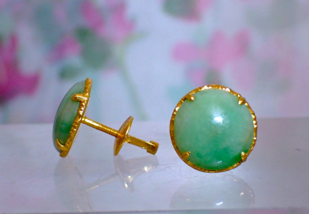 A pair of round green jade cabochon stud earrings held in textured 18ct gold claw settings. View II