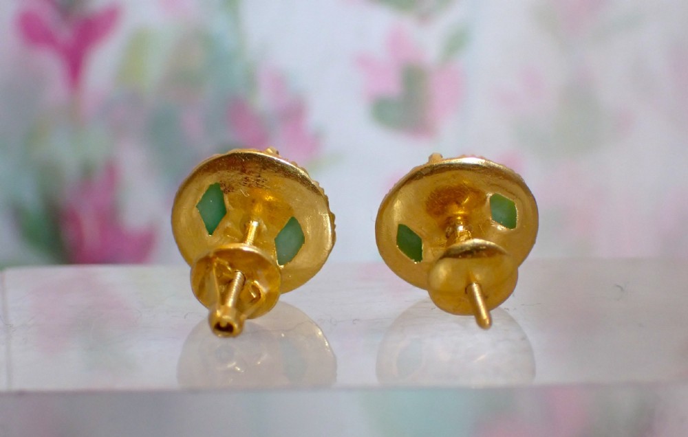 A pair of round green jade cabochon stud earrings held in textured 18ct gold claw settings. View III