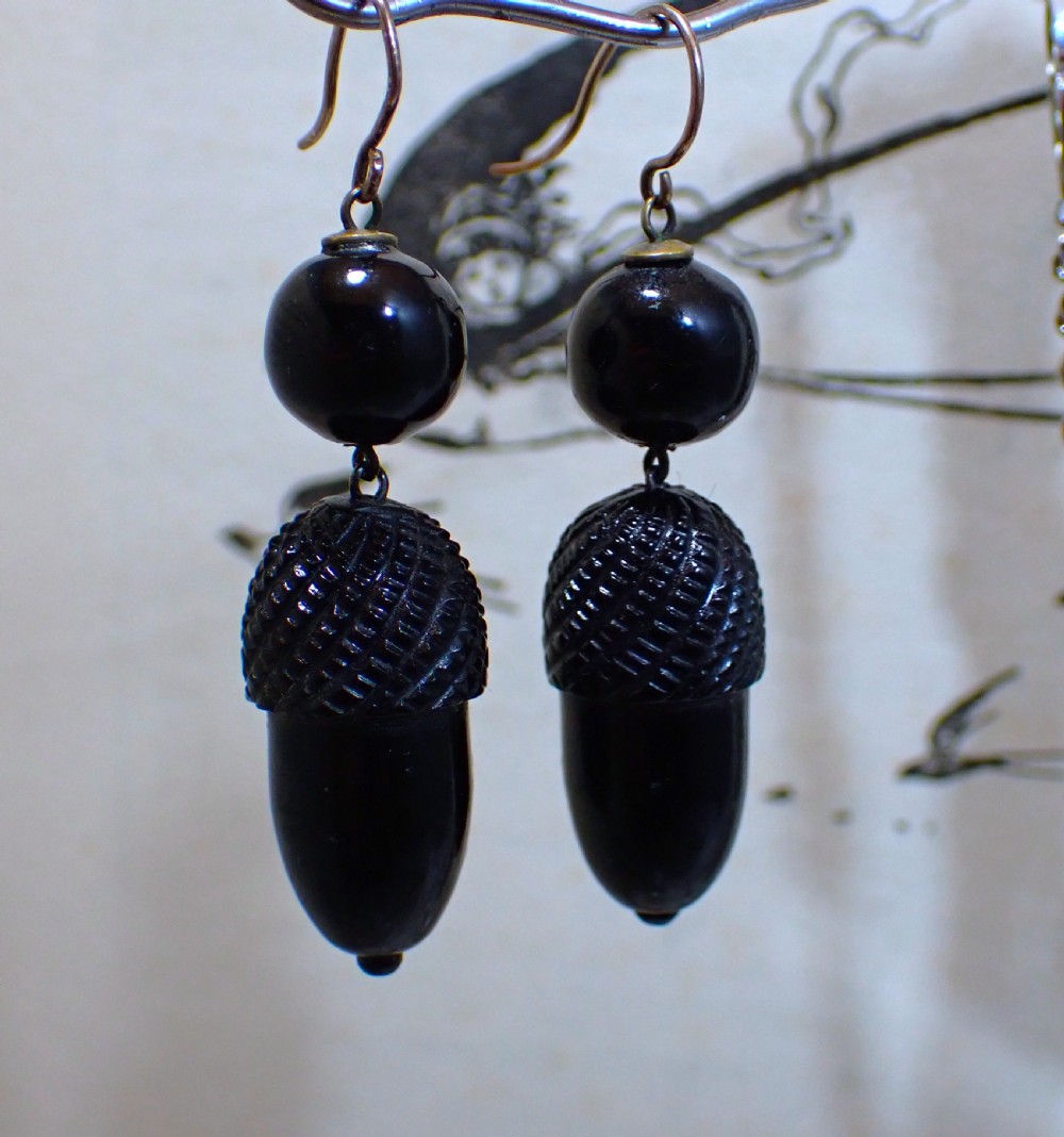 Pair of Victorian drop earrings featuring hand-carved black Whitby jet acorns beneath smooth round jet beads, fitted with 9ct gold ear wires.