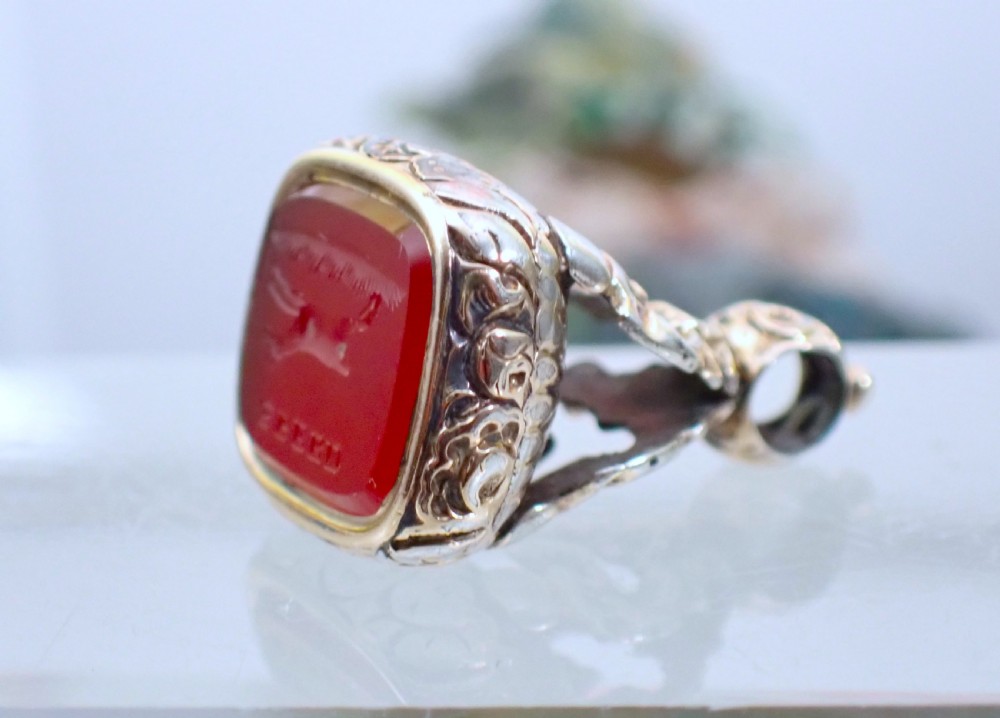 A Georgian gold cased fob seal featuring a carved red carnelian intaglio depicting a galloping horse under the engraved word SPEED. View IV