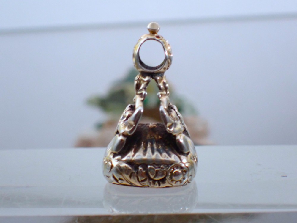 A Georgian gold cased fob seal featuring a carved red carnelian intaglio depicting a galloping horse under the engraved word SPEED. View V