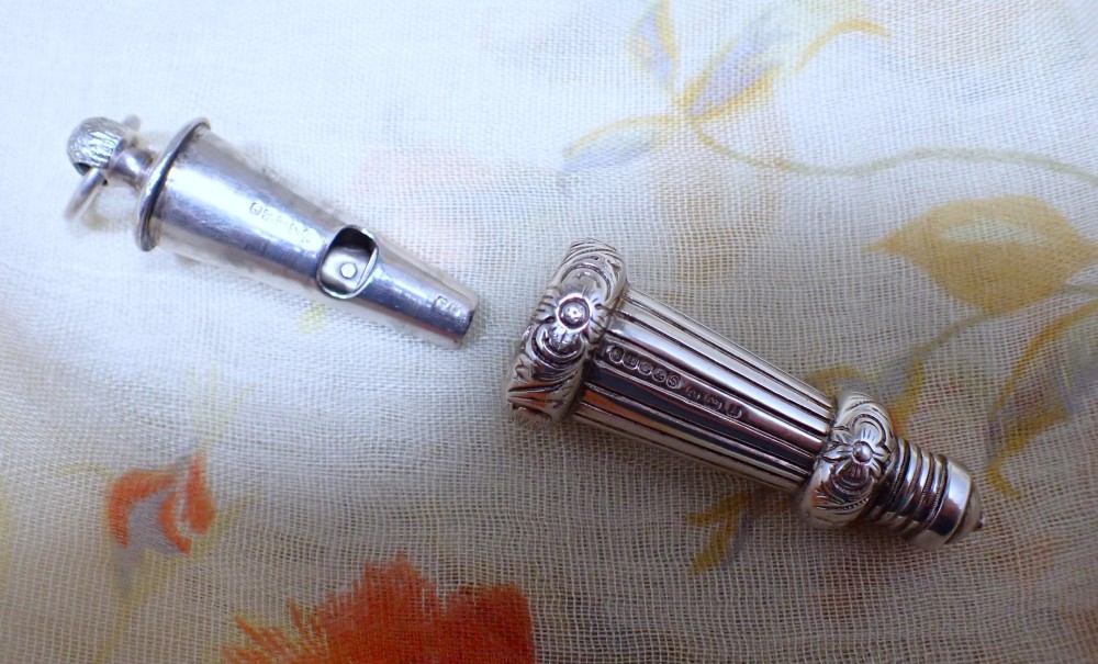 An ornate antique Edwardian sterling silver whistle pendant featuring engraved floral motifs, fluted detailing, and visible English silver hallmarks. View IV