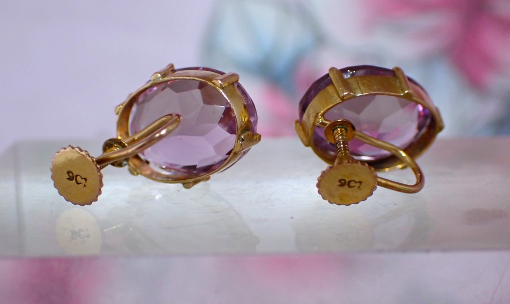 A pair of Edwardian 9ct yellow gold stud earrings set with oval faceted light purple amethyst gemstones and screw-back fastenings. View III