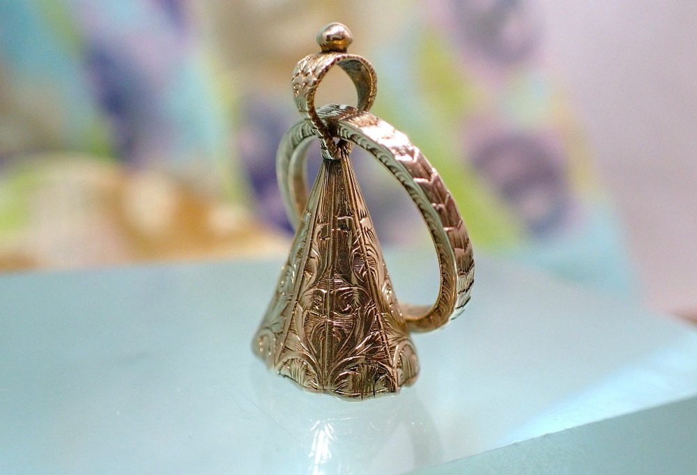 An antique 15ct gold conical fob seal featuring hand-engraved scroll motifs attached to a matching gold split ring. View III