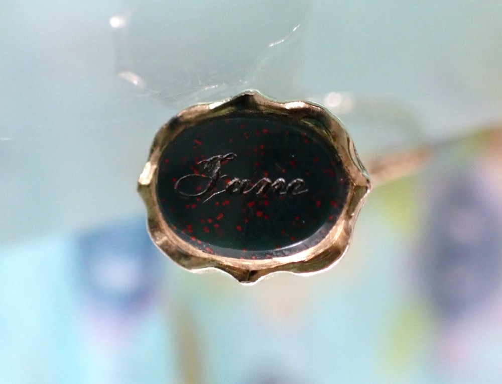 An antique 15ct gold conical fob seal featuring hand-engraved scroll motifs attached to a matching gold split ring. View IV