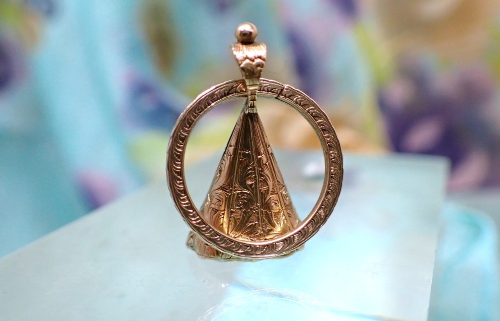 An antique 15ct gold conical fob seal featuring hand-engraved scroll motifs attached to a matching gold split ring. View VI