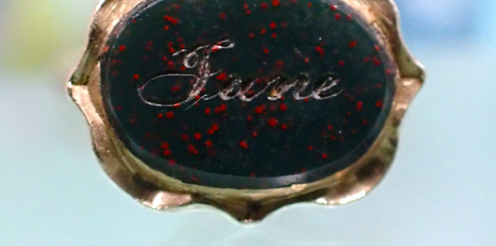 An antique 15ct gold conical fob seal featuring hand-engraved scroll motifs attached to a matching gold split ring. View VII