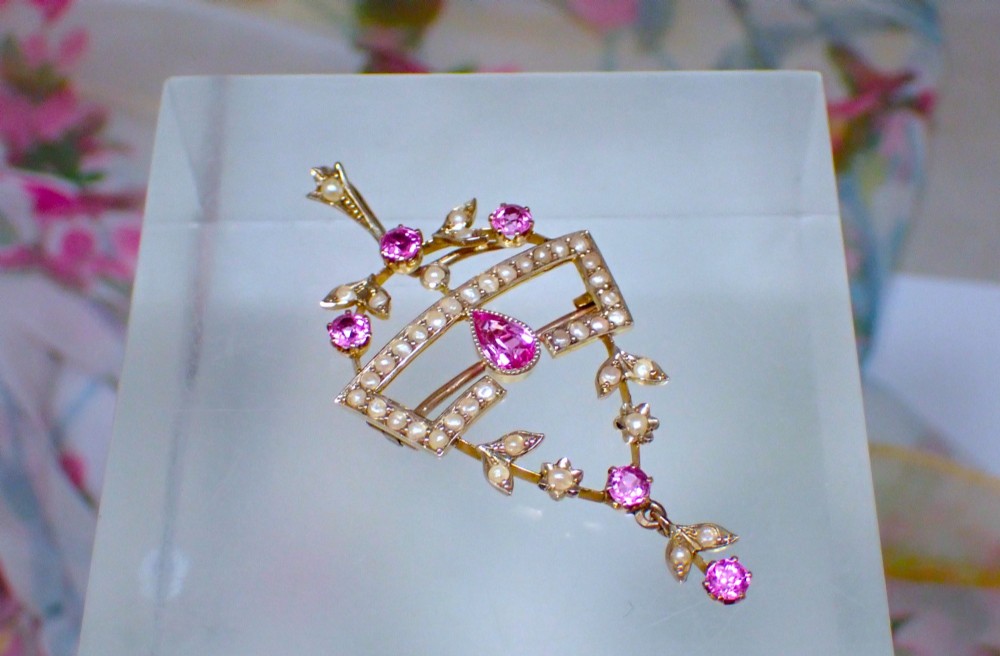 An Edwardian 15ct gold openwork pendant brooch set with natural pink tourmalines and seed pearls, featuring a central pear-cut gemstone drop. View III