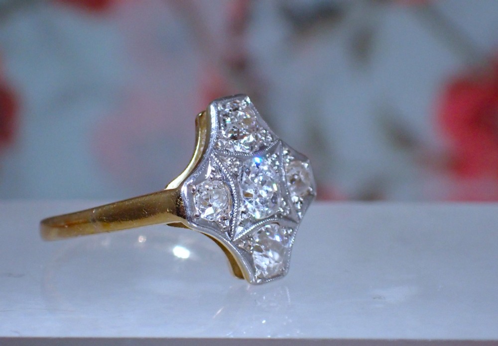 An Art Deco diamond ring featuring a geometric platinum plaque setting mounted on an 18ct yellow gold band. View III