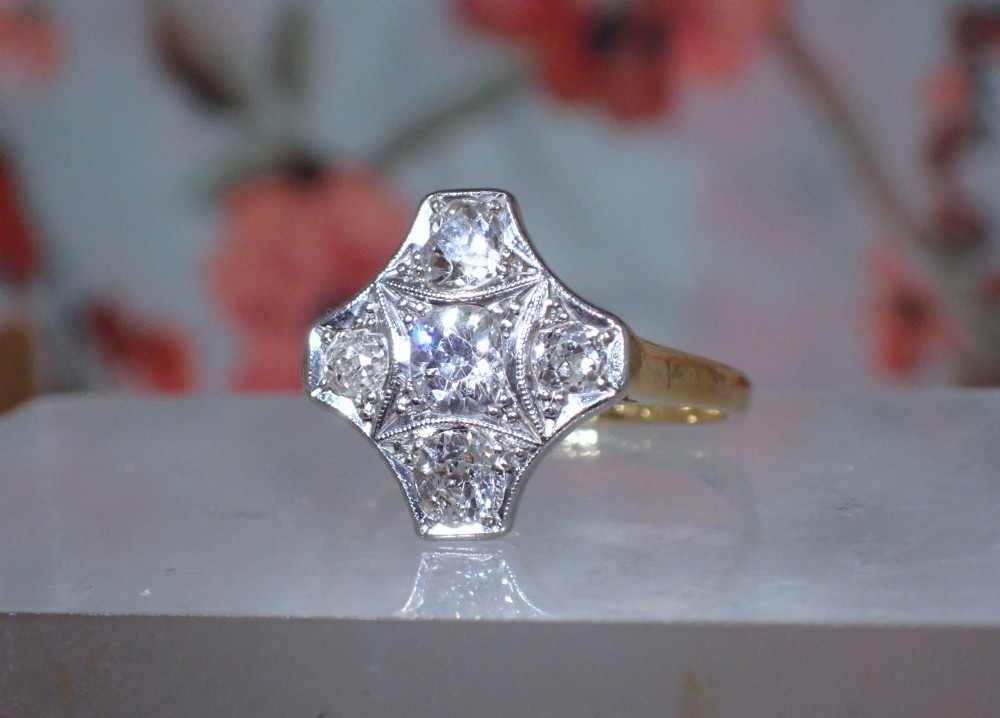 An Art Deco diamond ring featuring a geometric platinum plaque setting mounted on an 18ct yellow gold band. View IV