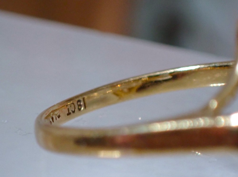 An Art Deco diamond ring featuring a geometric platinum plaque setting mounted on an 18ct yellow gold band. View VII