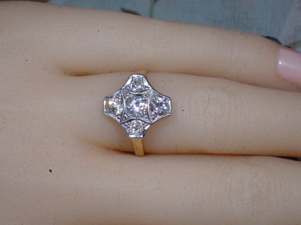 An Art Deco diamond ring featuring a geometric platinum plaque setting mounted on an 18ct yellow gold band. View IX