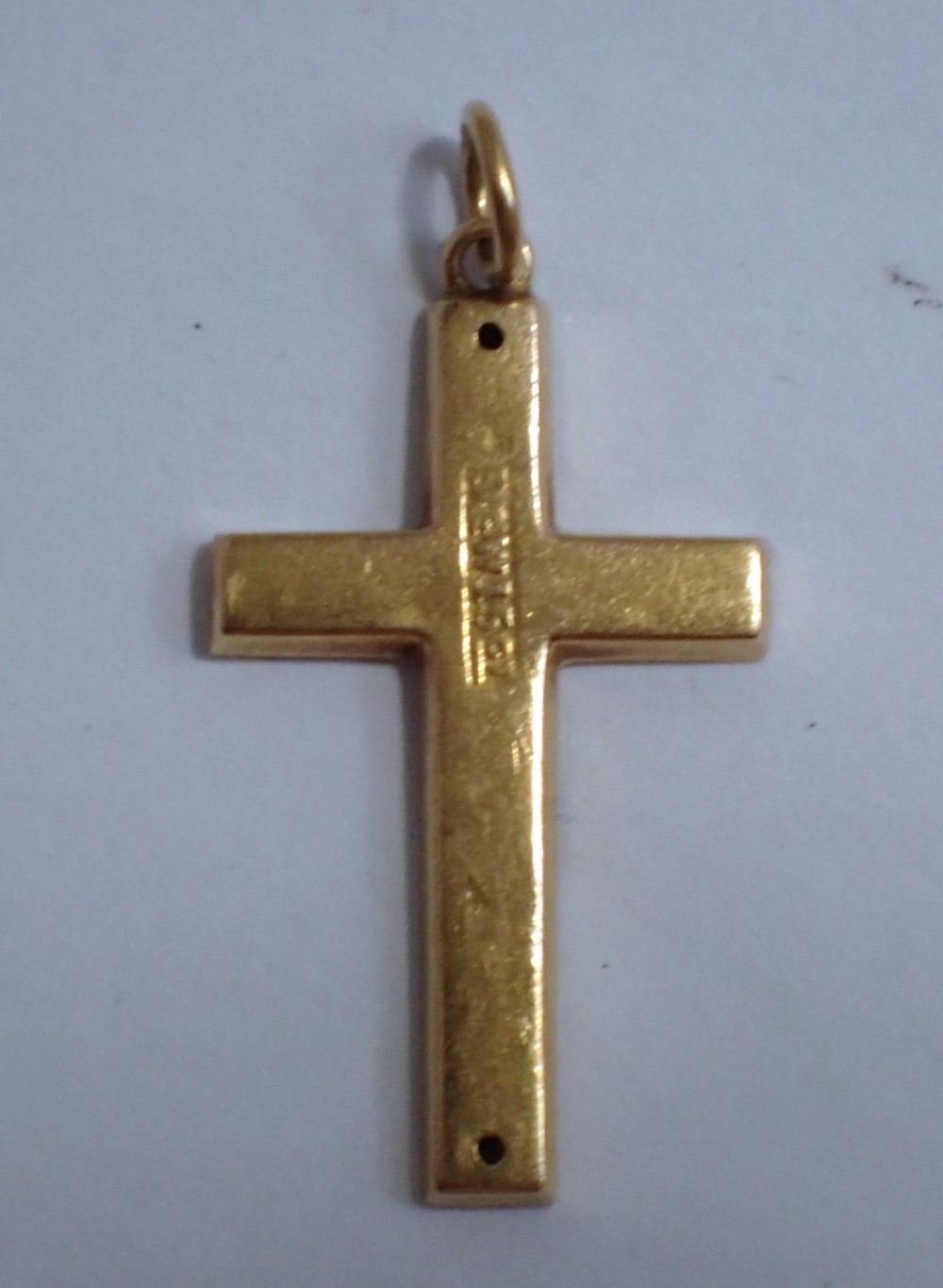 A Victorian 15ct yellow gold cross pendant featuring hand-engraved foliate patterns and a suspension ring at the top. View III