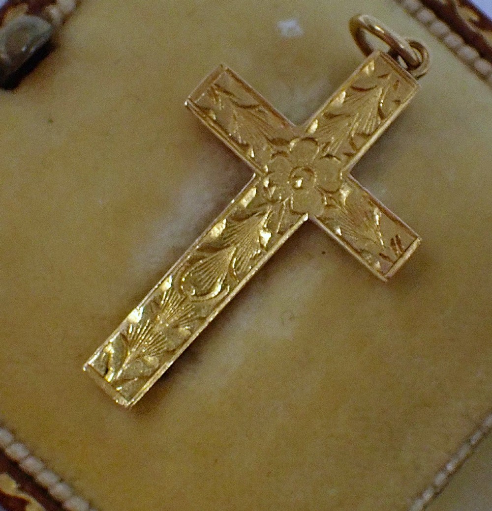 A Victorian 15ct yellow gold cross pendant featuring hand-engraved foliate patterns and a suspension ring at the top. View IV