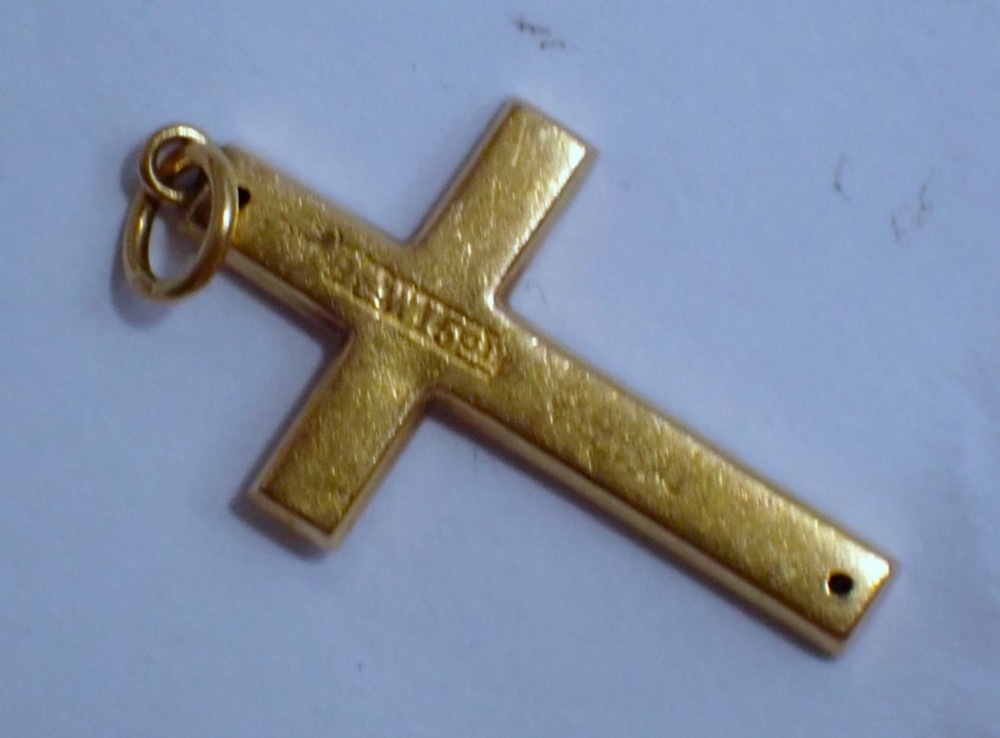 A Victorian 15ct yellow gold cross pendant featuring hand-engraved foliate patterns and a suspension ring at the top. View V