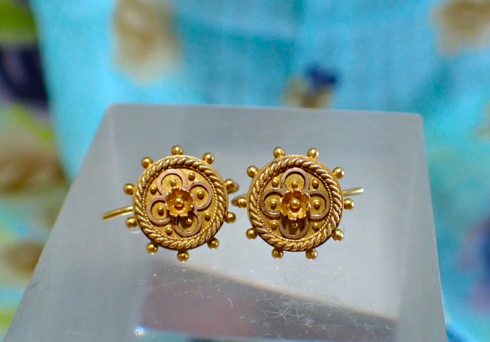 A pair of Victorian 15ct gold circular stud earrings featuring Etruscan Revival wirework, bead granulation, and a central floral rosette.