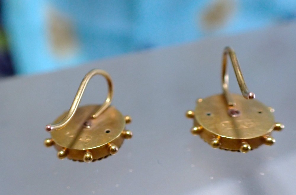 A pair of Victorian 15ct gold circular stud earrings featuring Etruscan Revival wirework, bead granulation, and a central floral rosette. View IV