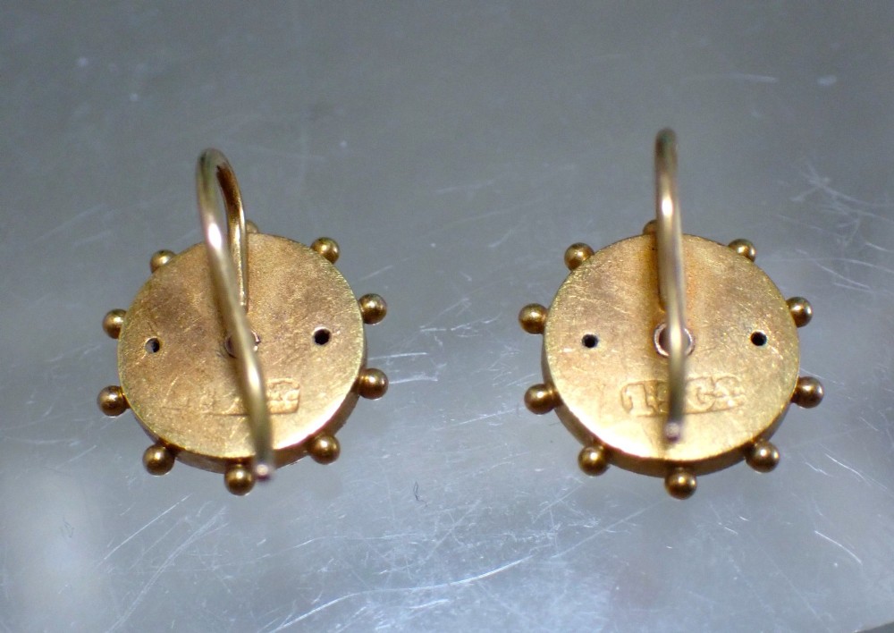 A pair of Victorian 15ct gold circular stud earrings featuring Etruscan Revival wirework, bead granulation, and a central floral rosette. View V