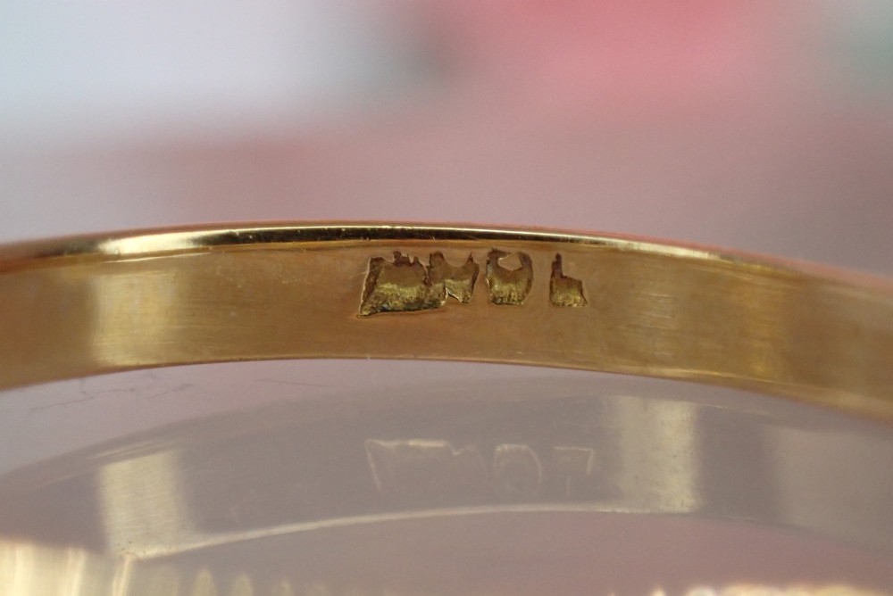 An 18ct yellow gold Victorian ring featuring three cushion cut diamonds set in a carved row along the band. View V