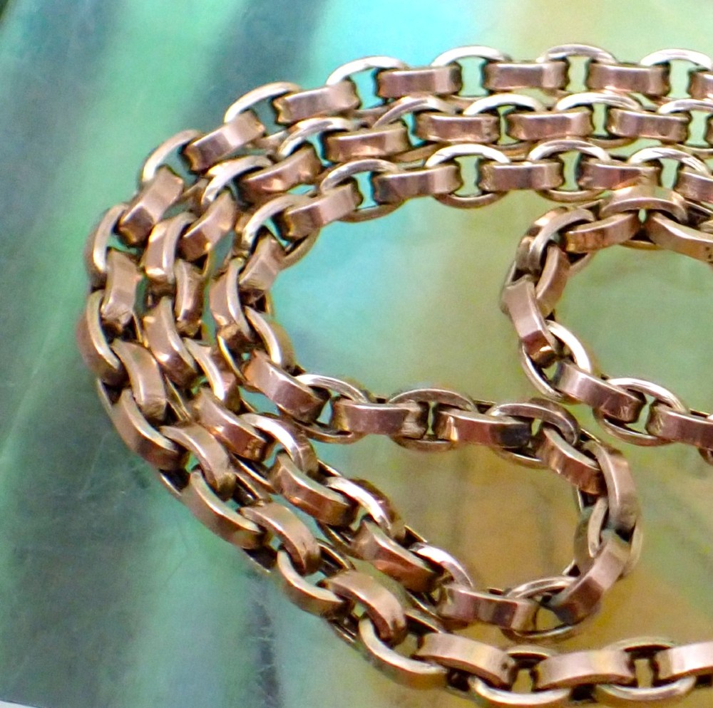 A close-up view of an antique Victorian 9ct yellow gold chain featuring interlocking rounded belcher links.