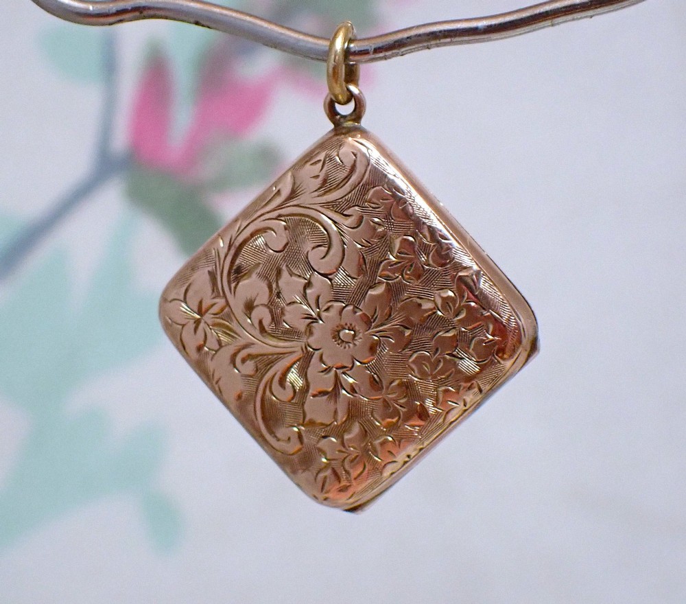 An antique Victorian square rose gold double fronted locket with hand engraved floral patterns and a heart cartouche. View II