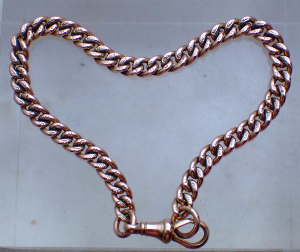 An Edwardian 9ct rose gold curb link bracelet featuring interlocking links and a traditional swivel clasp closure. View II