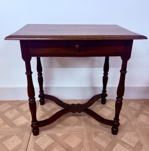 fig 1. A late 17th-century dark oak side table with turned legs, a single frieze drawer, and a shaped X-frame stretcher.