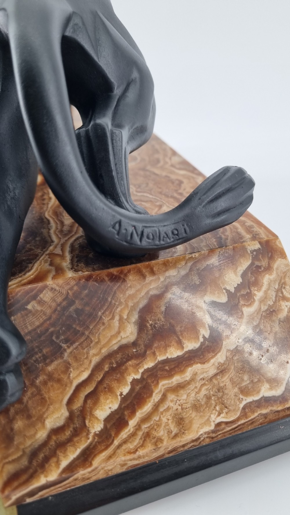 A black Art Deco cubist sculpture of a snarling panther mounted on a layered marble and onyx base. View VI