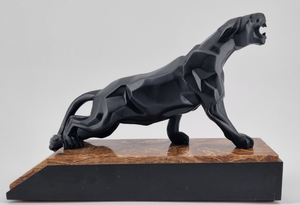 A black Art Deco cubist sculpture of a snarling panther mounted on a layered marble and onyx base. View VII