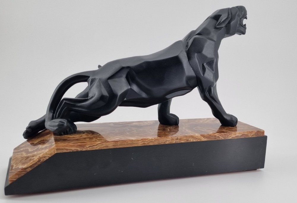 A black Art Deco cubist sculpture of a snarling panther mounted on a layered marble and onyx base. View VIII