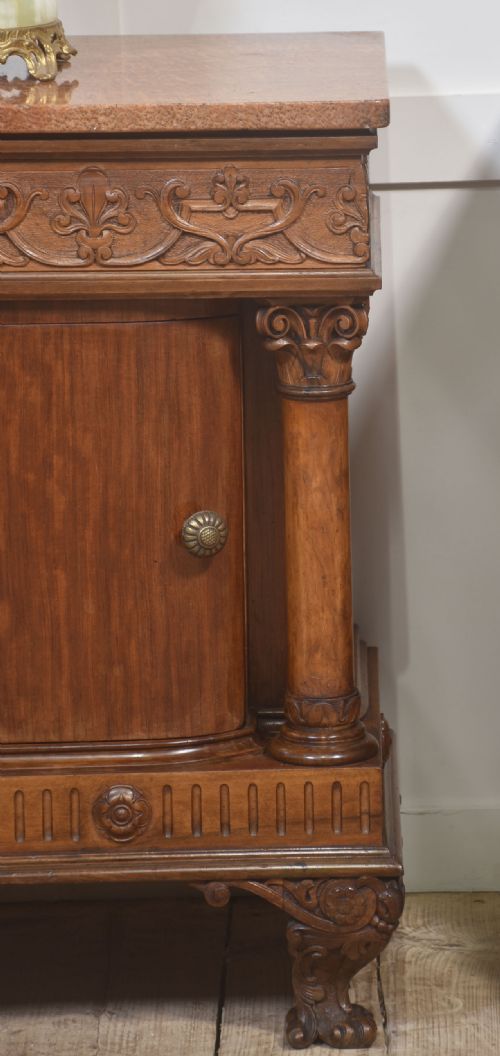 fig 2. A pair of carved warm brown mahogany bedside cabinets featuring classical columns, frieze carvings, and single panel doors on carved feet.