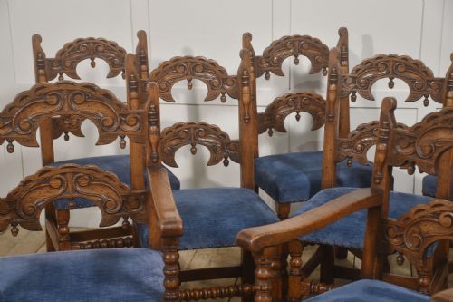 fig 2. A set of eight Jacobean Revival carved oak dining chairs with blue velvet upholstered seats, including two carver armchairs and six side chairs.