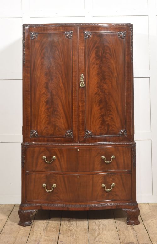 FIGURED MAHOGANY TALLBOY LINEN PRESS WITH CARVED DETAIL