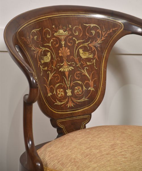 fig 1. An Edwardian mahogany tub armchair displaying foliate marquetry inlay across the curved back splat and cabriole legs, paired with a textured cream seat.